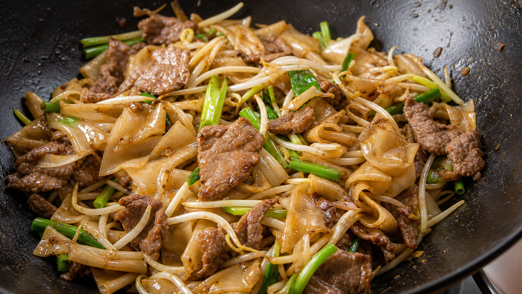 Cantonese beef chow fun with intact rice noodles, tender beef and bean sprouts