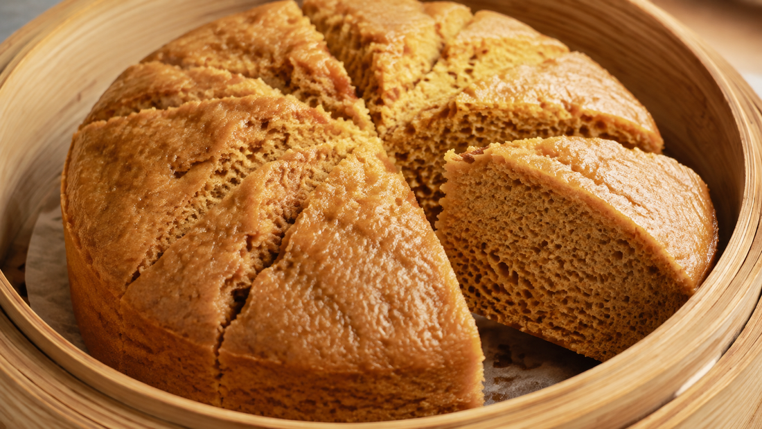 Golden Cantonese ma lai go steamed sponge cake with sliced wedges showing a honeycomb crumb