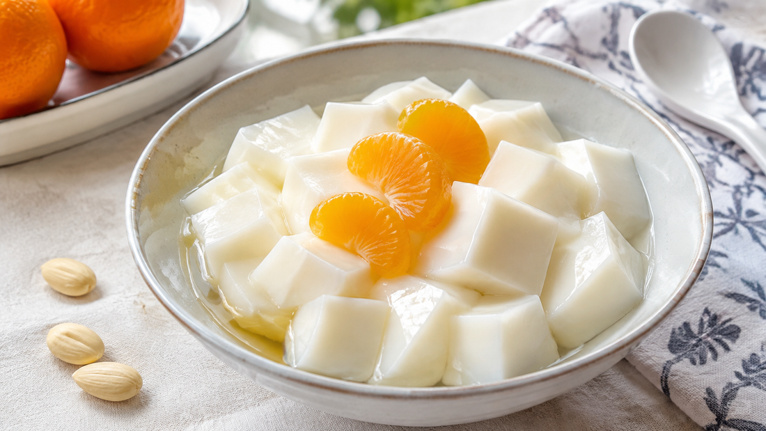 Silky Chinese almond tofu cubes in light syrup with mandarin orange segments and blanched almonds