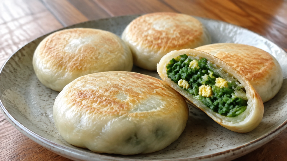 Pan-fried Chinese chive pockets with one cut open to show chive, egg and glass noodle filling