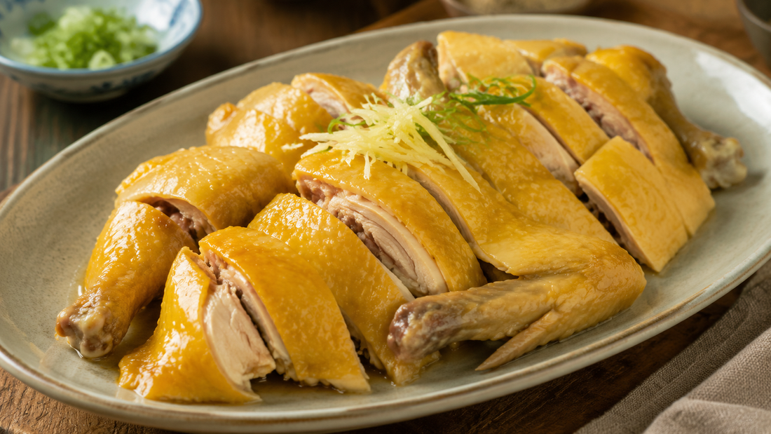 Golden Hakka salt-baked chicken cut into serving pieces with ginger and scallions