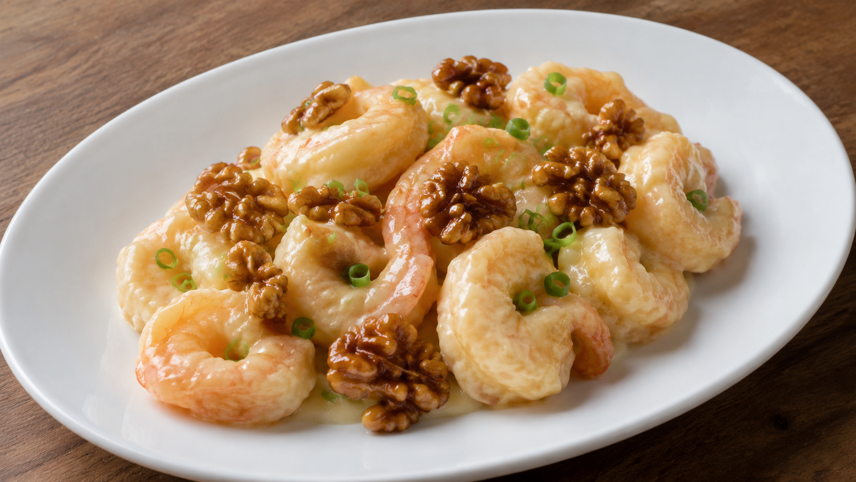 Honey walnut shrimp in creamy sauce topped with caramelized walnut halves and sliced scallions