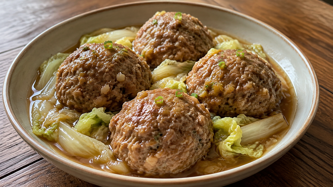 Four Chinese Lion's Head pork meatballs braised with tender napa cabbage