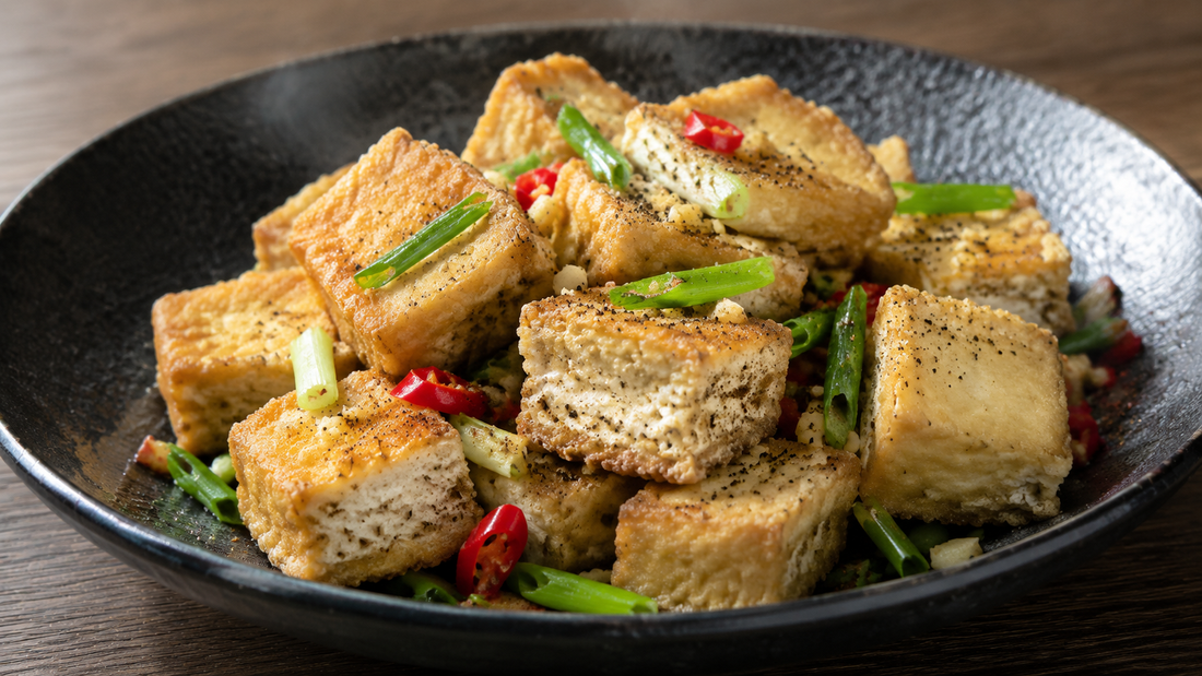 Crisp Chinese salt and pepper tofu cubes with garlic, scallions, red chile and black pepper